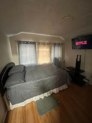a bed in a bedroom with a sign that reads melatonin at Cozy Apartment 2 BedroomS in Hillside