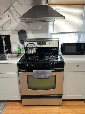 a kitchen with a stove with a tea pot on it at Cozy Apartment 2 BedroomS in Hillside