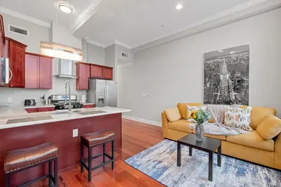 a living room with a couch and a table at Luxury 1BR - Glass Wall & Window in Philadelphia