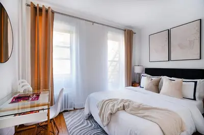 a white bedroom with a large bed and a window at 444-3A Newly renovated 1BR - Elevator Building in New York