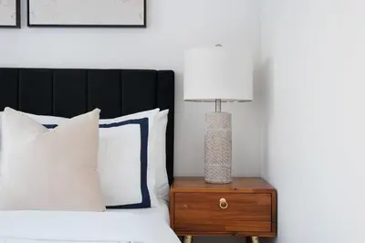 a lamp on a night stand next to a bed at 444-3A Newly renovated 1BR - Elevator Building in New York