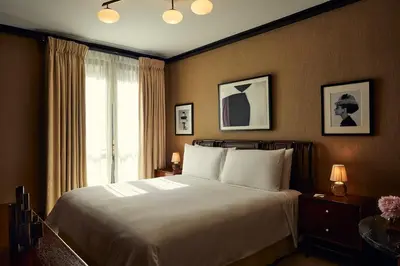 a bedroom with a large bed and a window at Fasano Fifth Avenue I Private Members Club & Hotel in New York