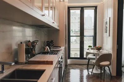 a kitchen with a sink and a table and a window at Fasano Fifth Avenue I Private Members Club & Hotel in New York