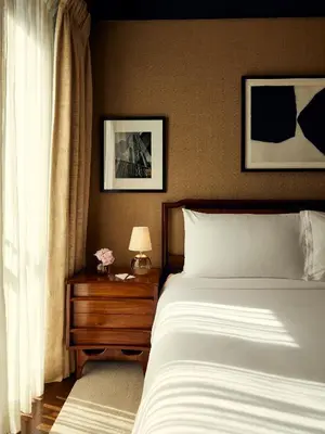 a bedroom with a bed and a table with a lamp at Fasano Fifth Avenue I Private Members Club & Hotel in New York