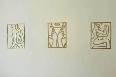 three drawings of people on a white wall at Belmont Suites - BR 2 (Private Room) - 30 mins to NYC in Newark