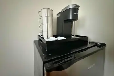 a black coffee maker sitting on top of a refrigerator at Belmont Suites - BR 2 (Private Room) - 30 mins to NYC in Newark