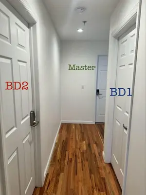a hallway with a door and a master bedroom at Belmont Suites - BR 2 (Private Room) - 30 mins to NYC in Newark
