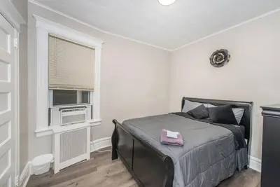 a bedroom with a bed and a window at Happiness in Harrison in Harrison