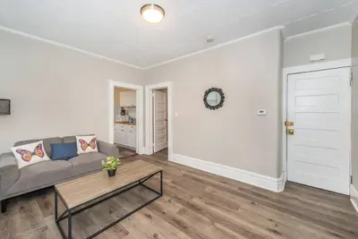 a living room with a couch and a table at Happiness in Harrison in Harrison