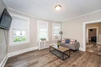 a living room with a couch and a table at Happiness in Harrison in Harrison