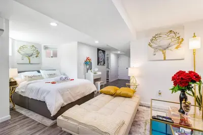 a bedroom with a large bed and a couch at Luxury Suite by Prudential Ctr & 7min to EWR Airpt in Newark