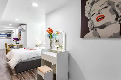a bedroom with a bed and a painting on the wall at Luxury Suite by Prudential Ctr & 7min to EWR Airpt in Newark