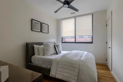 a bedroom with a bed and a ceiling fan at Downtown Princeton Chic in Princeton