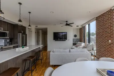 a kitchen and living room with a brick wall at Downtown Princeton Chic in Princeton