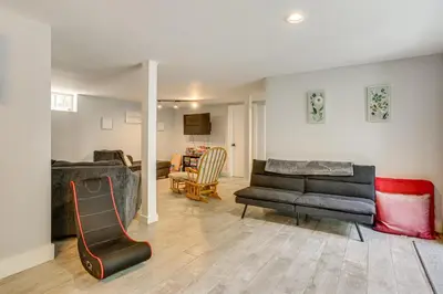 a living room with two couches and a table at Walk to Mohican Lake Catskills Getaway with Dock! in Glen Spey