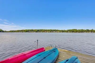 two boats sitting on a dock on a lake at Walk to Mohican Lake Catskills Getaway with Dock! in Glen Spey