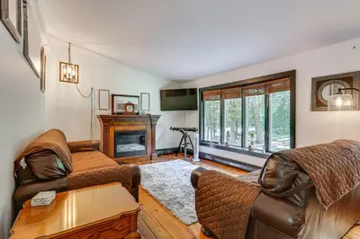 a living room with two couches and a fireplace at Walk to Mohican Lake Catskills Getaway with Dock! in Glen Spey