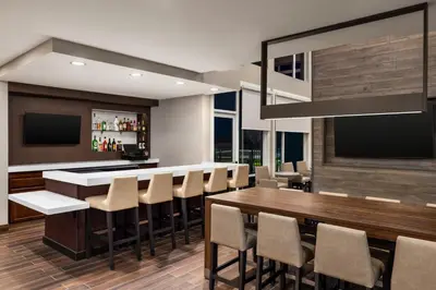 a dining room with a bar with stools at Residence Inn by Marriott Mechanicsburg in Mechanicsburg