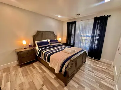 a bedroom with a large bed and a window at The Trendy Suite - Upgraded 2BR with Luxe Amenities in Paterson