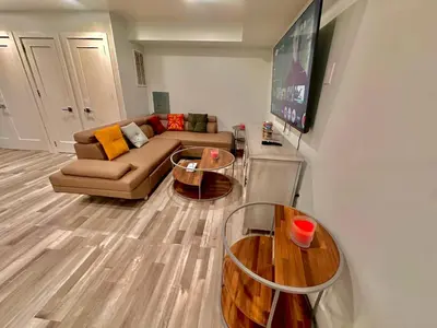 a living room with a couch and two tables at The Trendy Suite - Upgraded 2BR with Luxe Amenities in Paterson