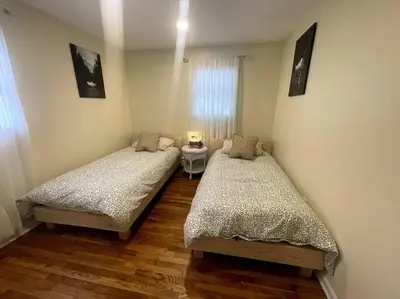 two twin beds in a room with wooden floors at Welcome to our Retreat Haven in Warwick, NY in Warwick