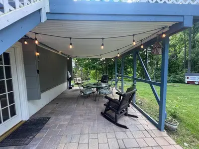 a patio with a table and chairs and lights at Welcome to our Retreat Haven in Warwick, NY in Warwick