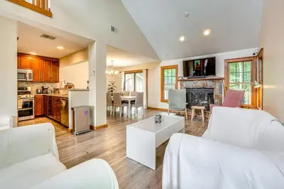 a living room with white furniture and a kitchen at Tannersville Resort Home with Deck and Gas Grill! in Tannersville