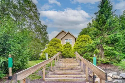 a wooden stairway leading to a house at Tannersville Resort Home with Deck and Gas Grill! in Tannersville