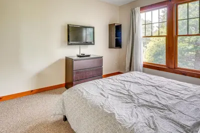 a bedroom with a bed and a tv on a dresser at Tannersville Resort Home with Deck and Gas Grill! in Tannersville