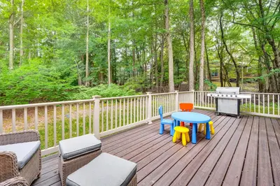 a deck with chairs and a table and a grill at Tannersville Resort Home with Deck and Gas Grill! in Tannersville
