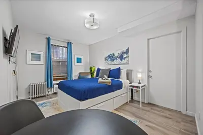 a bedroom with a bed and a table in it at Central Location Studio, Walk to Times Square in New York