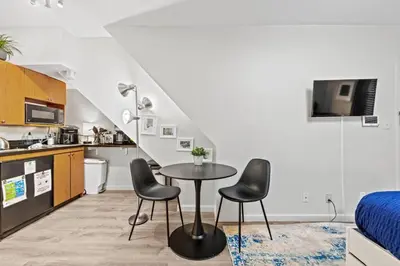 a small kitchen with a table and chairs in a room at Central Location Studio, Walk to Times Square in New York