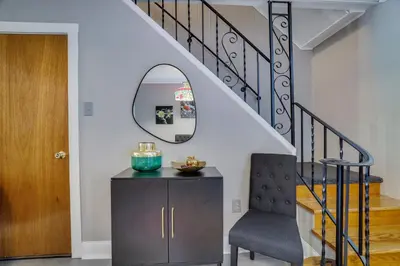 a stairway with a chair and a mirror at Home on Broadway in Jim Thorpe in Jim Thorpe