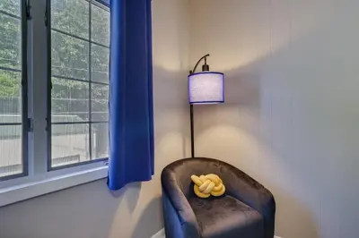 a stuffed animal sitting in a chair next to a window at Home on Broadway in Jim Thorpe in Jim Thorpe
