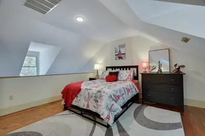 a bedroom with a bed and a dresser and a window at In The Heart Of Jim Thorpe (with your own parking) in Jim Thorpe