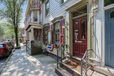 a building with red doors on a city street at In The Heart Of Jim Thorpe (with your own parking) in Jim Thorpe