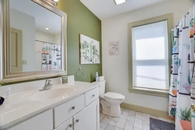 a bathroom with a sink and a toilet and a mirror at In The Heart Of Jim Thorpe (with your own parking) in Jim Thorpe