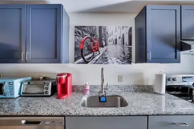 a kitchen counter with a sink and a picture of a street at In The Heart Of Jim Thorpe (with your own parking) in Jim Thorpe