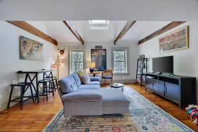 a living room with a couch and a tv at In The Heart Of Jim Thorpe (with your own parking) in Jim Thorpe