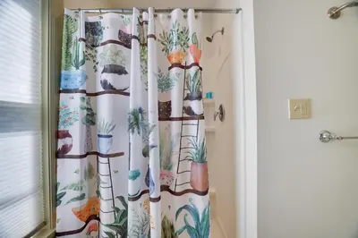 a shower curtain with plants on it in a bathroom at In The Heart Of Jim Thorpe (with your own parking) in Jim Thorpe