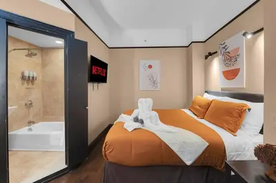 a bedroom with a large bed and a bath tub at Stunning Condo in Heart of New York with GYM & MORE in New York