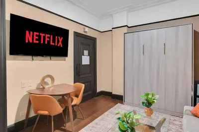 a living room with a netflix sign on the wall at Stunning Condo in Heart of New York with GYM & MORE in New York