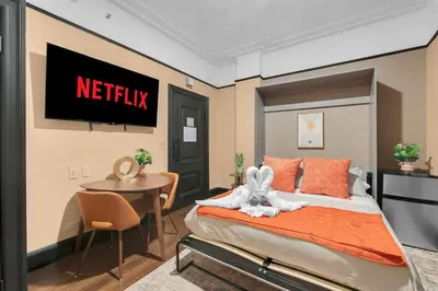 a bedroom with a netflix sign on the wall at Stunning Condo in Heart of New York with GYM & MORE in New York