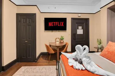 a bedroom with a bed and a table and a sign that reads netflix at Stunning Condo in Heart of New York with GYM & MORE in New York