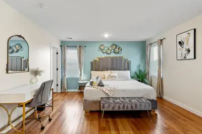 a bedroom with a bed and a desk in it at Luxury Gated home near NYC and EWR with free Parking in Elizabeth