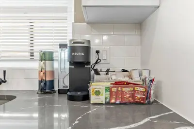 a kitchen counter with a coffee maker on a counter top at Luxury Gated home near NYC and EWR with free Parking in Elizabeth