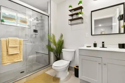 a bathroom with a shower and a toilet and a sink at Luxury Gated home near NYC and EWR with free Parking in Elizabeth