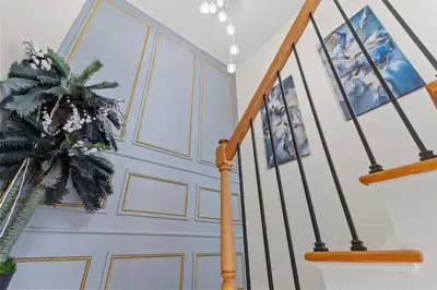 a staircase with blue and white walls and a stair case at Luxury Gated home near NYC and EWR with free Parking in Elizabeth