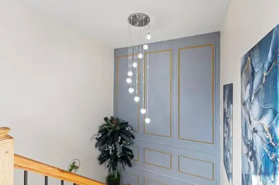 a chandelier hanging from a ceiling in a room at Luxury Gated home near NYC and EWR with free Parking in Elizabeth