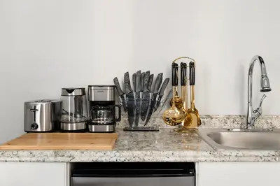 a kitchen counter with appliances on a counter top at 73-1504 Newly Reno Studio UWS Doorman Gym Laundry in New York